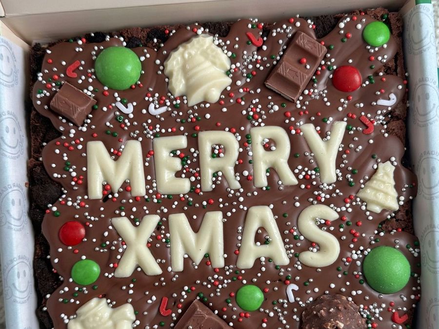 A Christmas brownie with MERRY XMAS in white chocolate letters