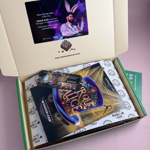 A brownie box with branded cards and flyers packed in on top