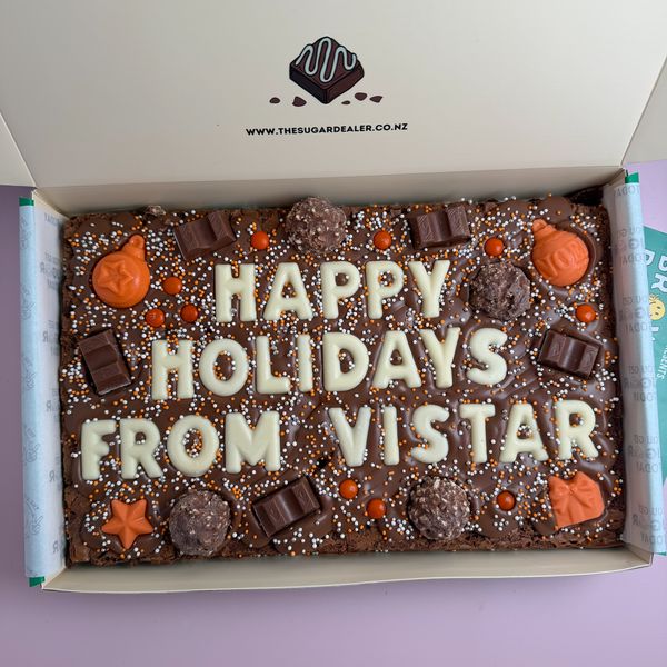 A Mega brownie reading HAPPY HOLIDAYS FROM VISTAR in white chocolate letters